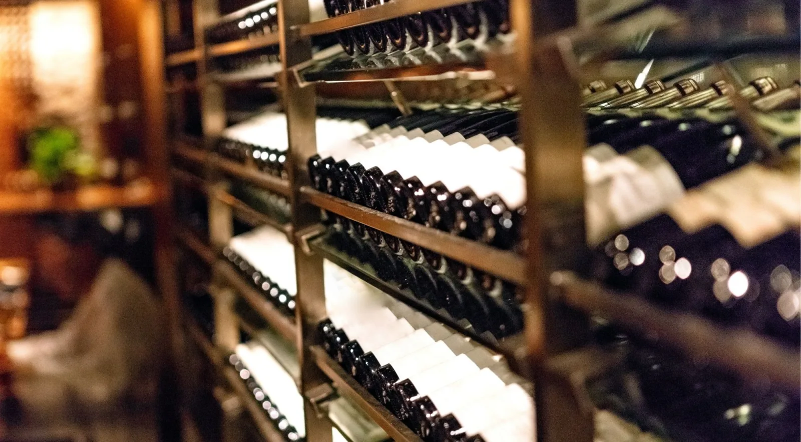 Rows of aging wine bottles in a Napa Valley winery cellar