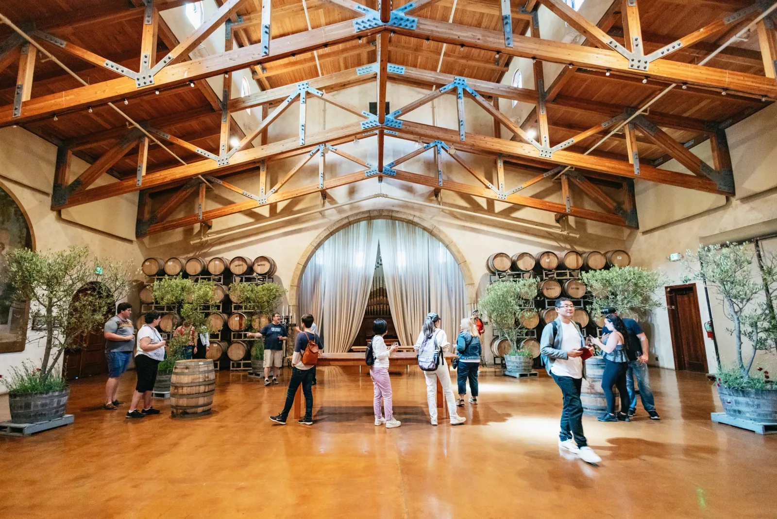 Guests gathered in a Napa Valley winery barrel room during a guided tasting