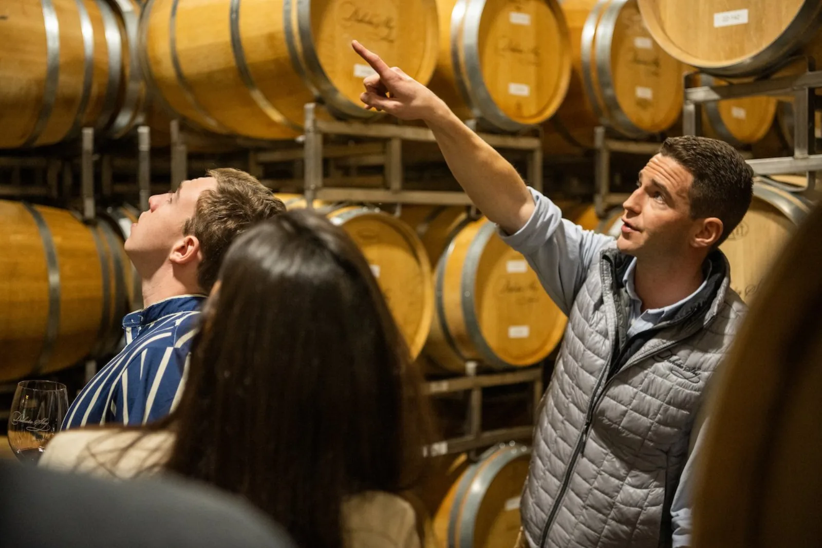 Winery guide pointing out barrels during a cellar tour